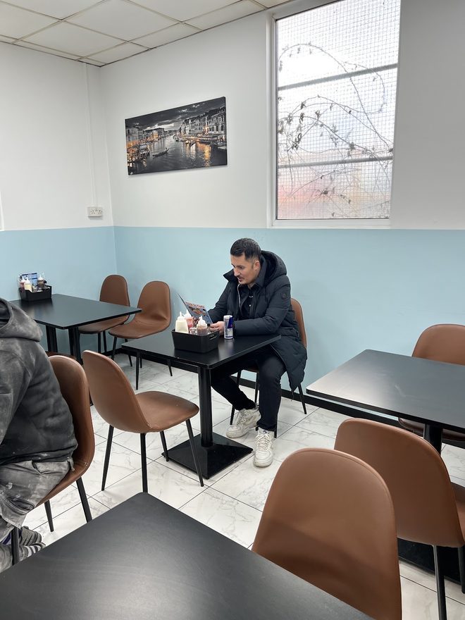 The seating area with pale blue walls and brown chairs